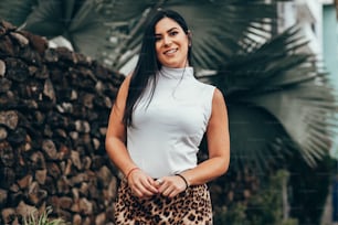 Portrait of elegant woman wearing white shirt and animal print skirt