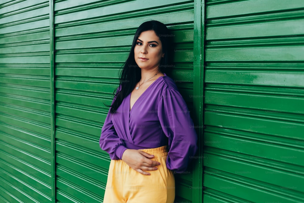 Outdoor fashion portrait of woman wearing clothes in complementary yellow and purple colors