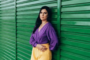 Outdoor fashion portrait of woman wearing clothes in complementary yellow and purple colors