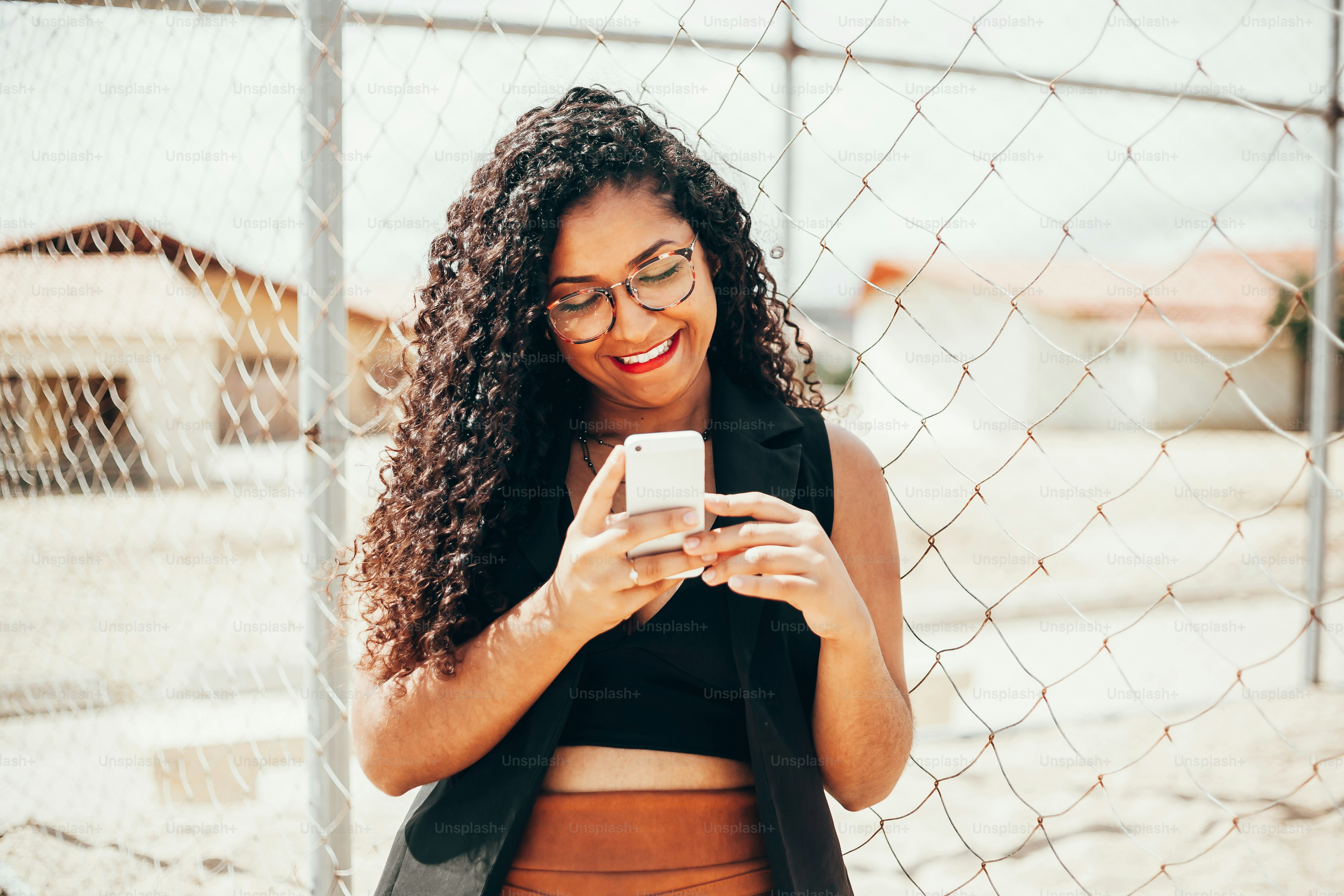 Young beautiful woman using smartphone outdoors
