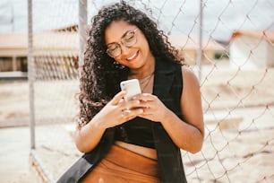 Young beautiful woman using smartphone outdoors