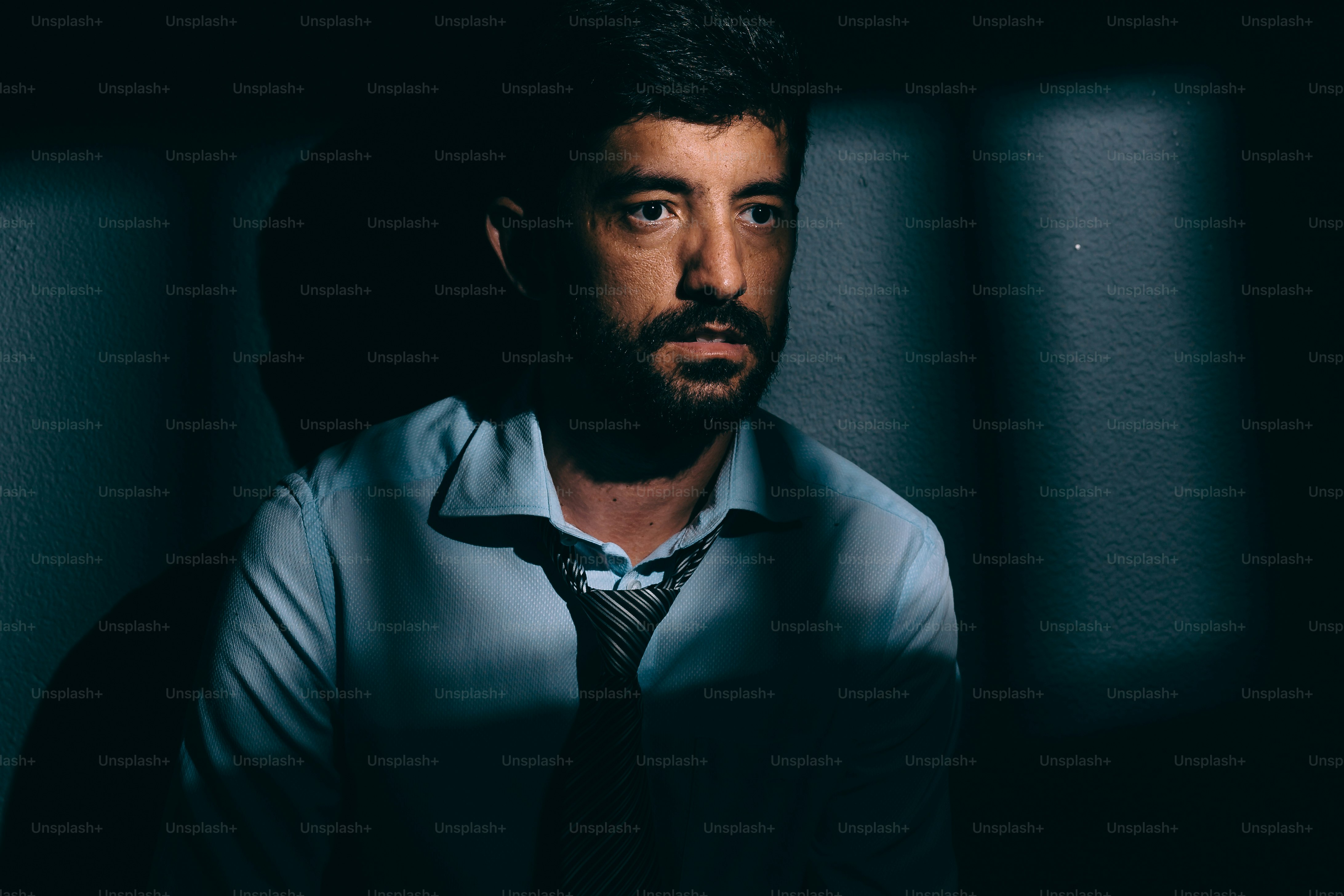 Businessman or political prisoner in dark cell. Concept of white collar crime