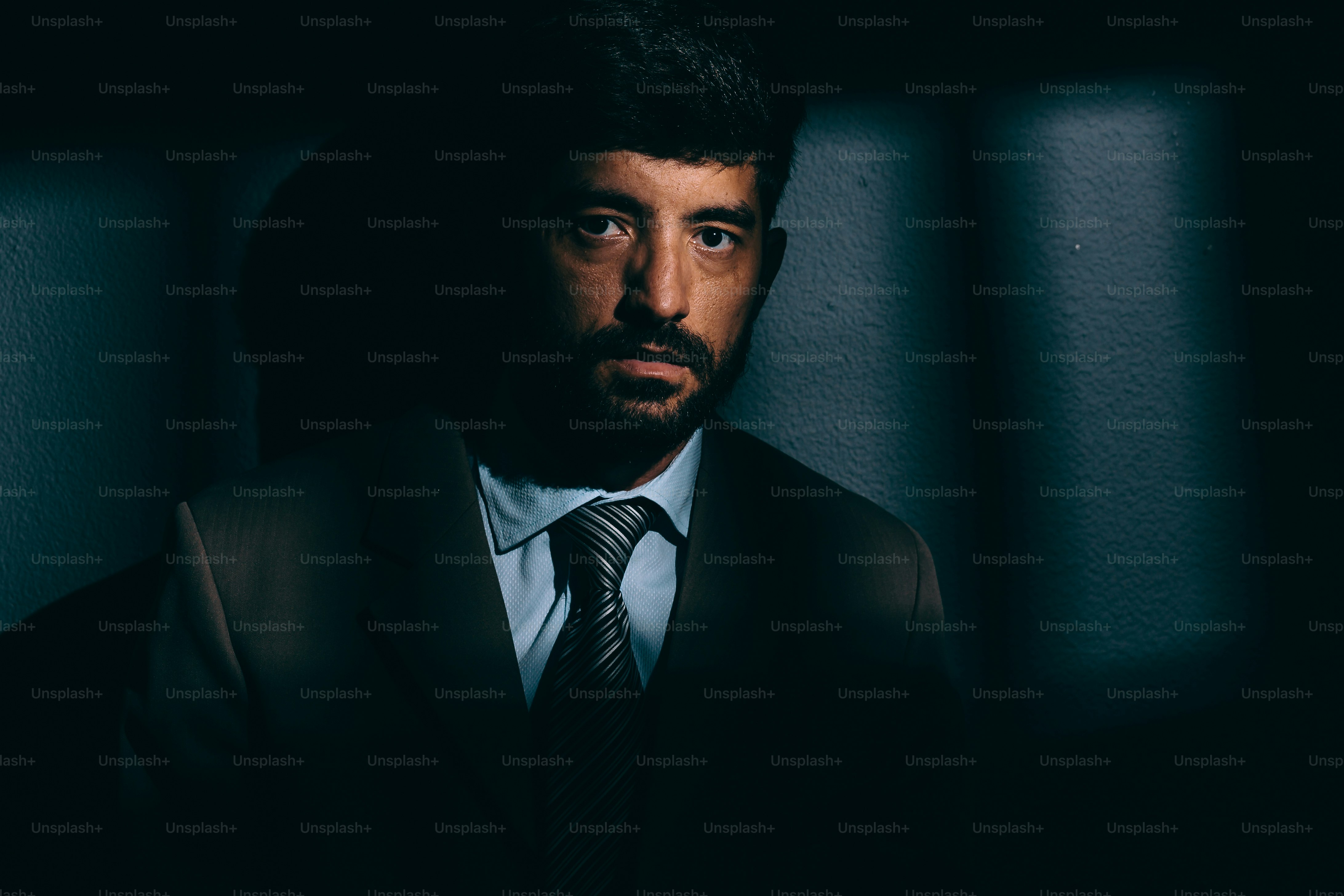 Businessman or political prisoner in dark cell. Concept of white collar crime