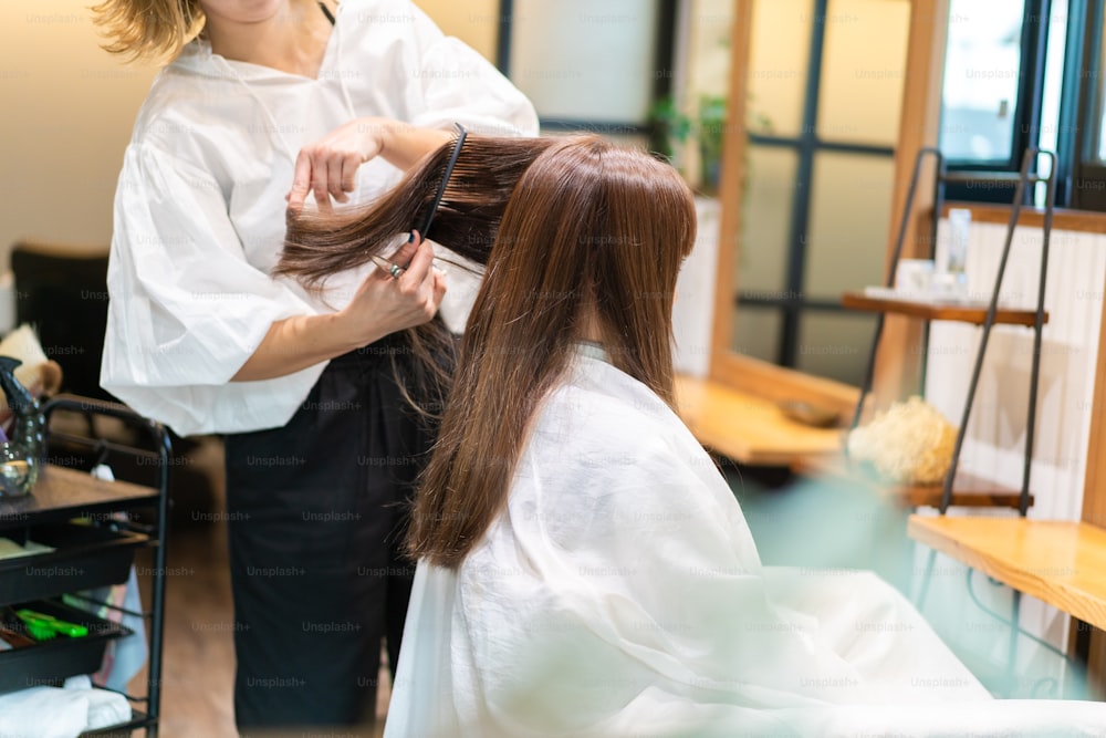 A woman getting her hair cut at a beauty salon