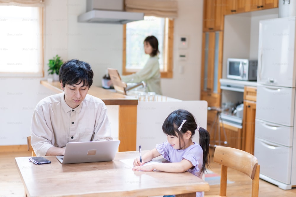 A couple and their child teleworking