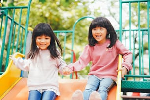 Two girls playing happily in the park