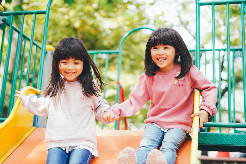 Two girls playing happily in the park