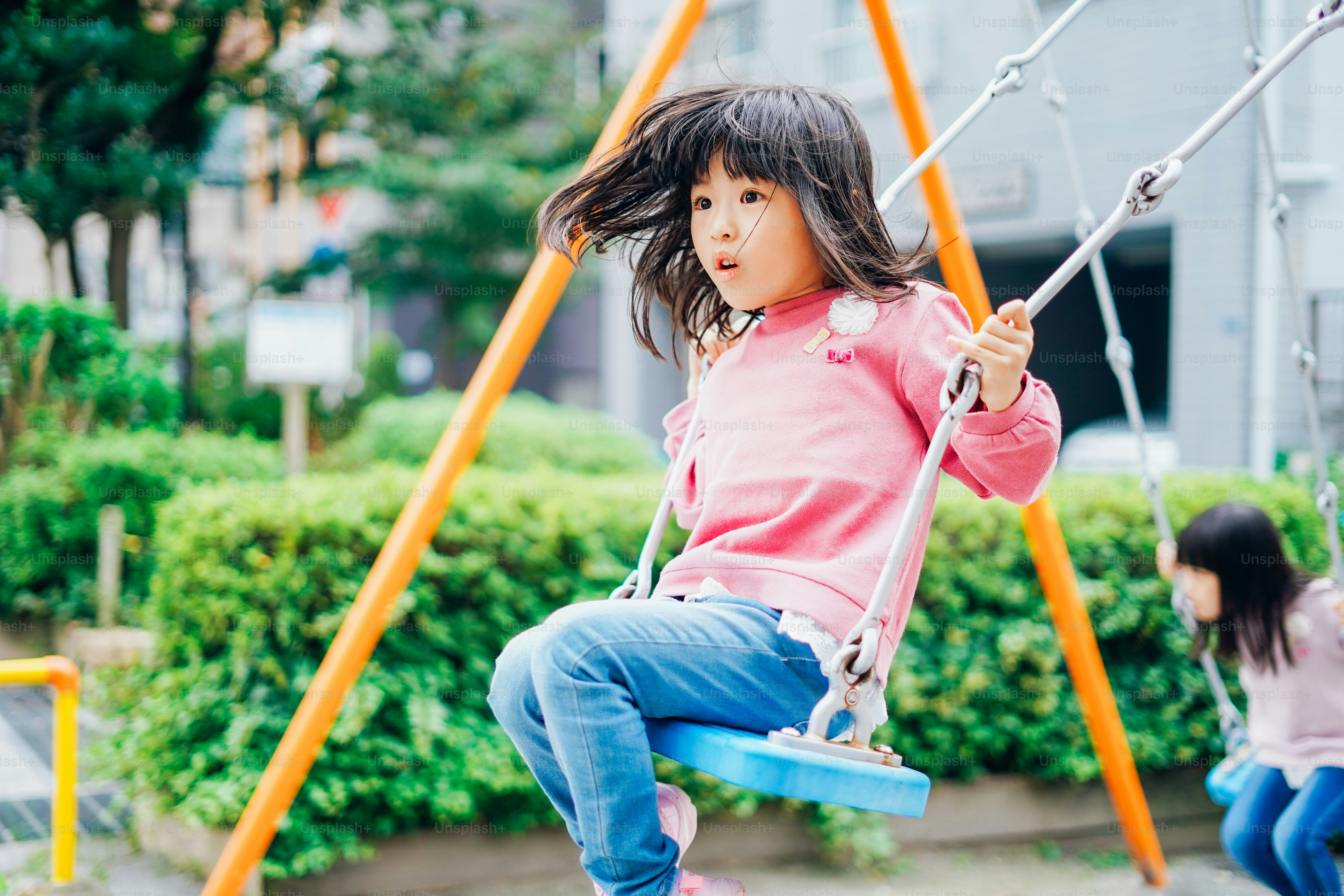 Girl playing with swing at a park