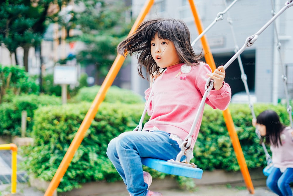Girl playing with swing at a park