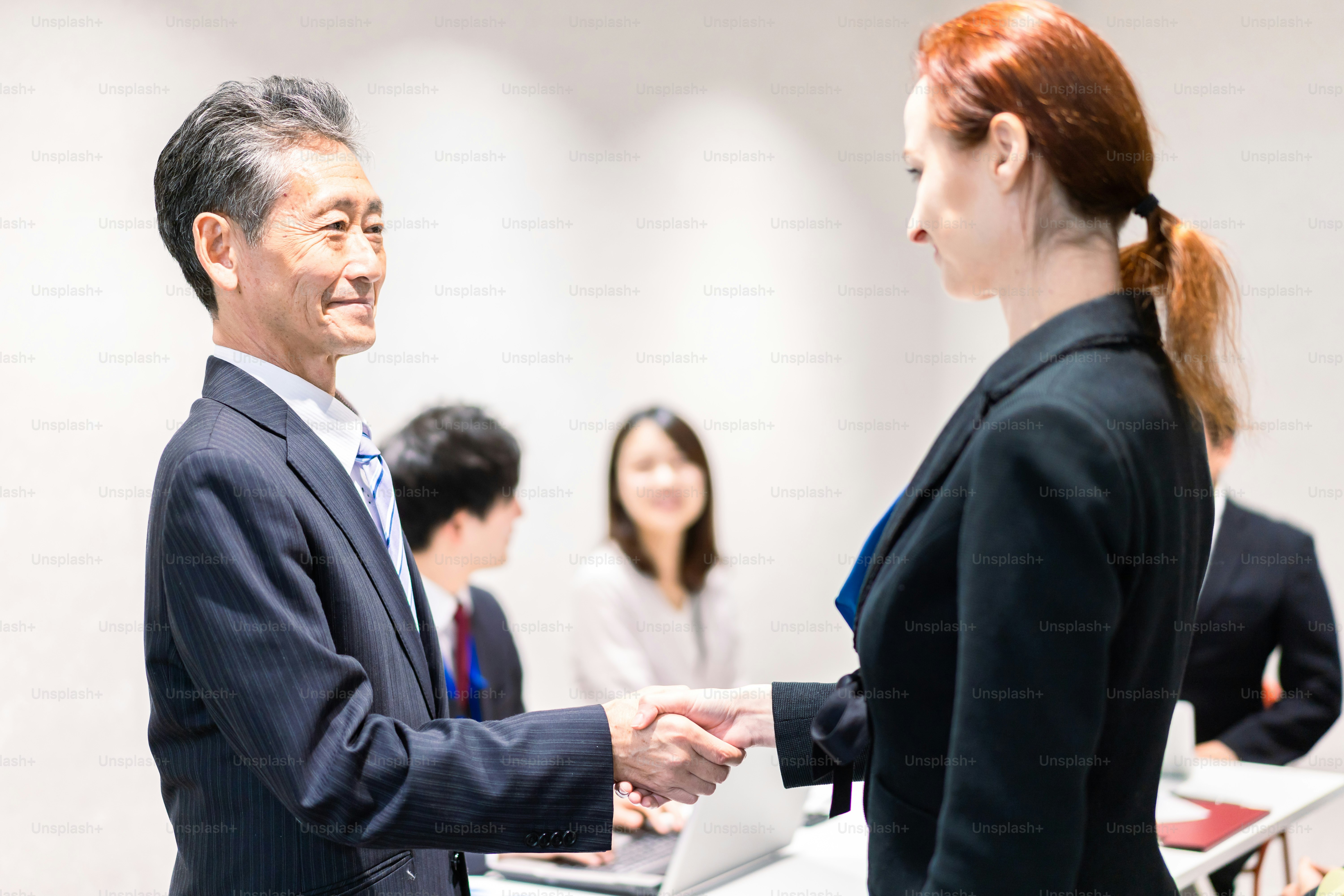 Business people signing a contract at a table