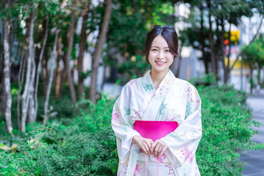 Young woman walking down the street in yukata