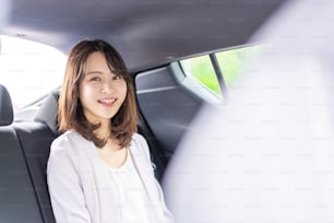 A busy career woman working in a cab