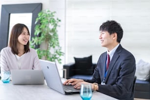Man and woman talking happily in an office