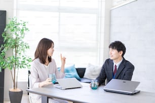 Man and woman talking happily in an office
