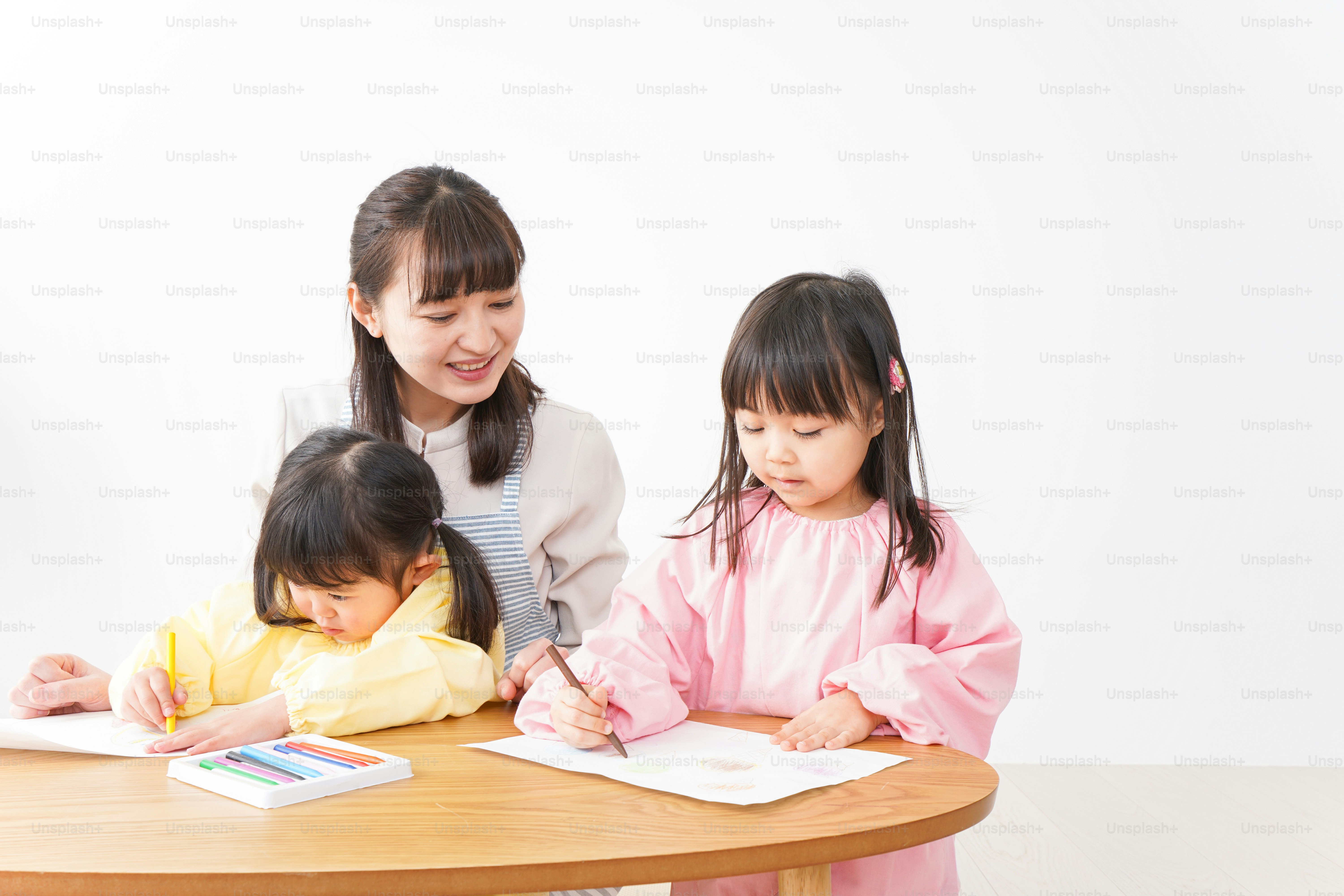 Children and teacher painting at preschool