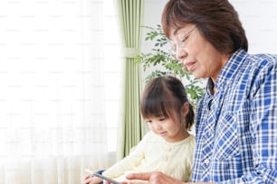 Enfant utilisant un smartphone avec grand-mère