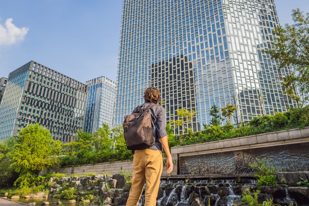 Joven turista en el arroyo Cheonggyecheon en Seúl, Corea. El arroyo Cheonggyecheon es el resultado de un proyecto masivo de renovación urbana. Concepto de viaje a Corea.