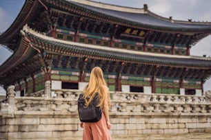 Woman tourist in korea. Gyeongbokgung Palace grounds in Seoul, South Korea. Travel to Korea concept.