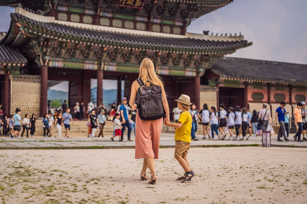 Mom and son tourists in Korea. Gyeongbokgung Palace grounds in Seoul, South Korea. Travel to Korea concept. Traveling with children concept.