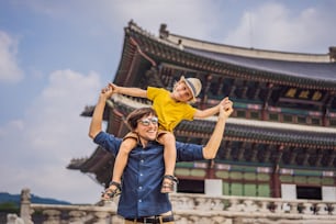 Dad and son tourists in Korea. Gyeongbokgung Palace grounds in Seoul, South Korea. Travel to Korea concept. Traveling with children concept.