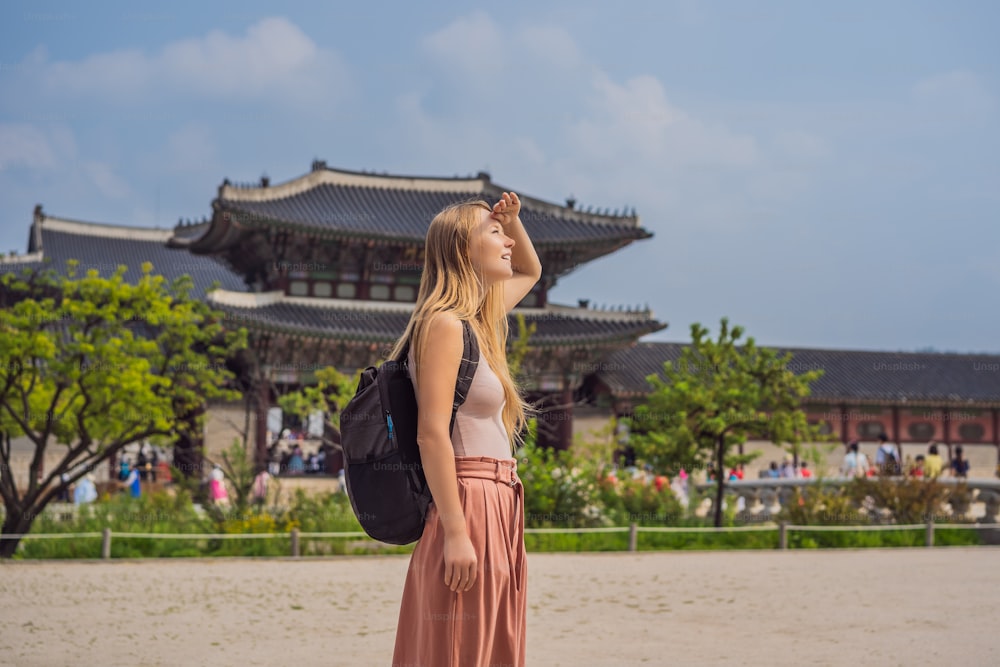 Woman tourist in korea. Gyeongbokgung Palace grounds in Seoul, South Korea. Travel to Korea concept.