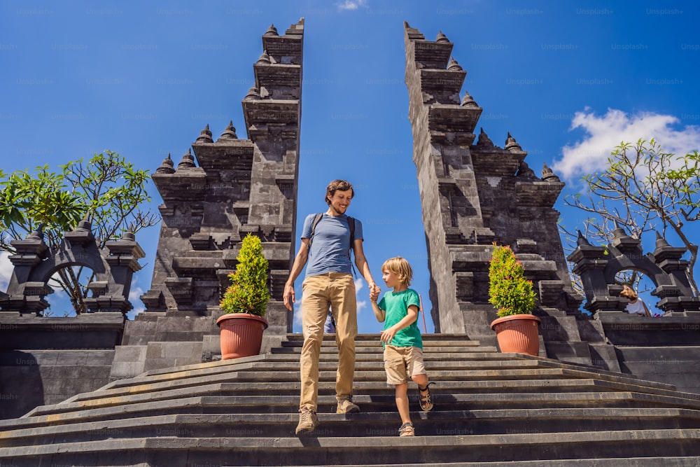 Dad and son tourists in budhist temple Brahma Vihara Arama Banjar Bali, Indonesia. Honeymoon.