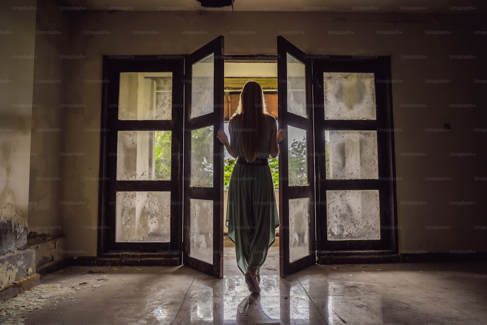 Woman tourist in abandoned and mysterious hotel in Bedugul. Indonesia, Bali Island. Bali Travel Concept.