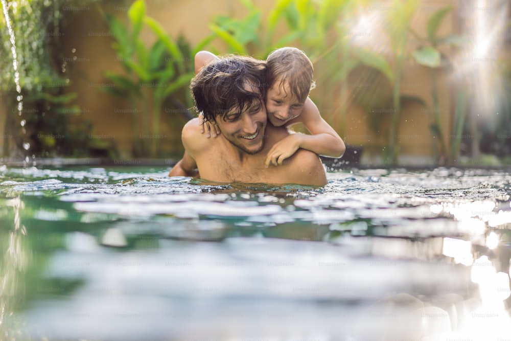 Dad and son have fun in the pool.