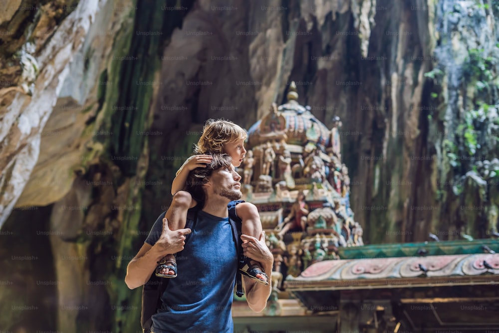 Father and son in the background of Batu Caves, near Kuala Lumpur, Malaysia. Traveling with children concept.