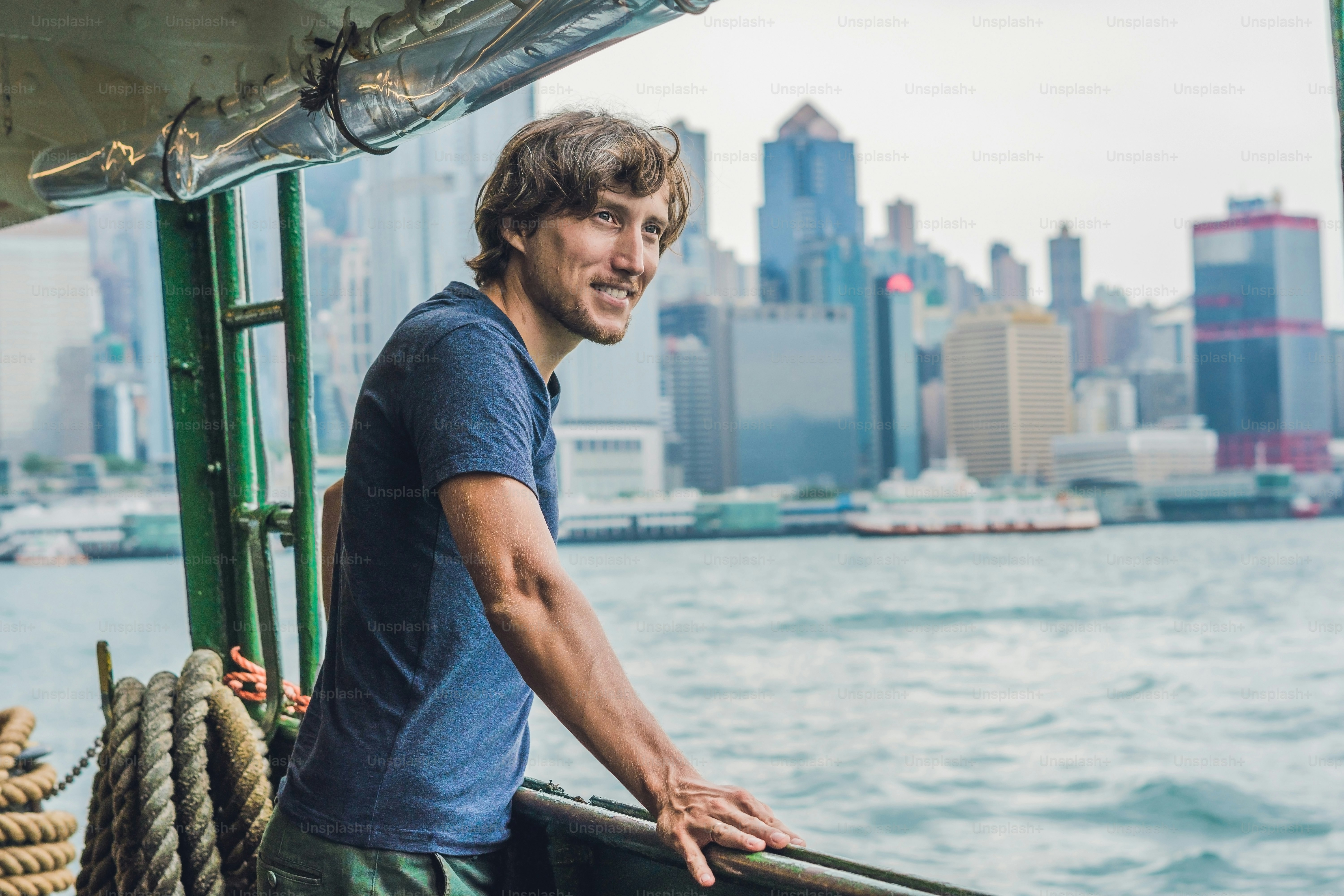 A young man on a ferry in Hong Kong.