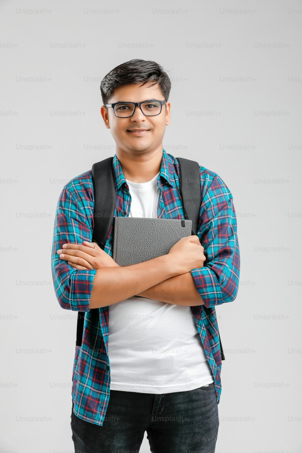 Indischer College-Junge mit Haltetasche und Büchern
