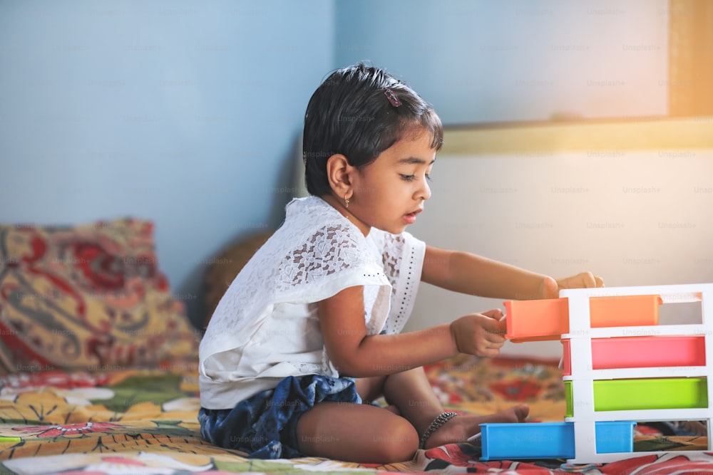 cute little indian girl playing at home