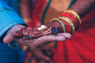 Golden engagement ring in bride and groom hand