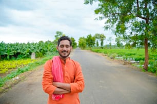 Indian farmer in traditional wear over nature background