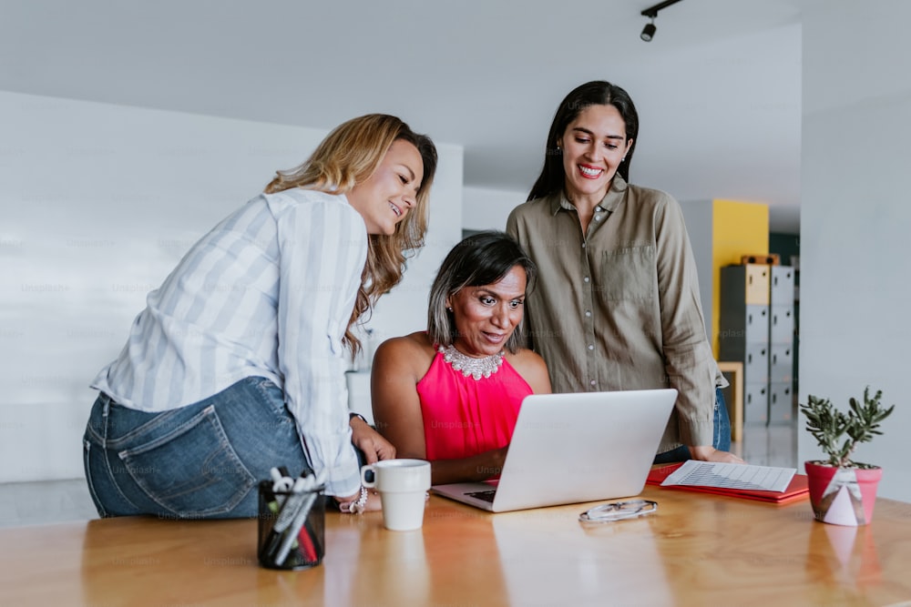 transgender latin woman working with woman coworkers at the office in Mexico Latin America