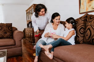 latin grandmother woman with daughter or grandchild celebrating birthday, 8 March International women holiday or Happy Mother's Day in Mexico city