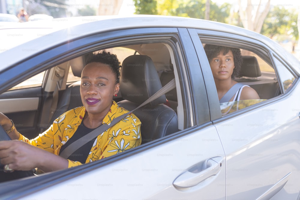 Portrait of a senior woman driving a car. Taxi app concept.