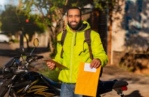 African american delivery man with envelope and delivery check sheet.