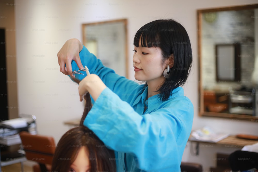 Image of a hairdresser practicing cutting hair