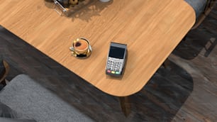木製のテーブルの上に座っている携帯電話
