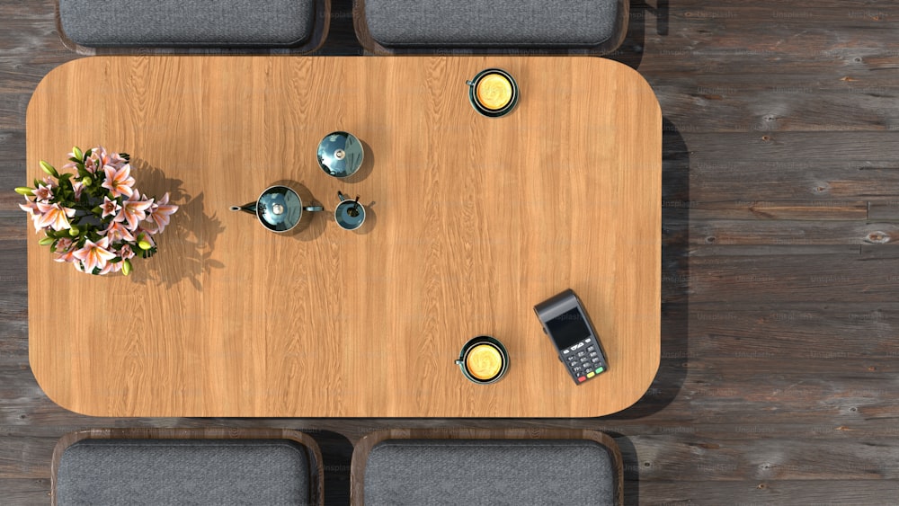 an overhead view of a table with a cell phone and a vase of flowers