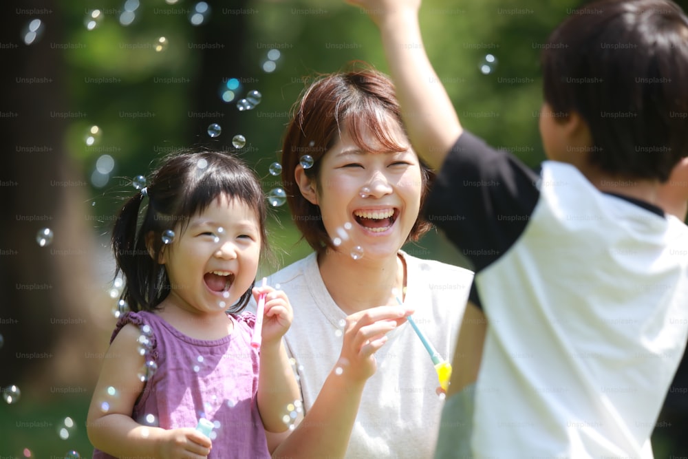 Parents and children playing with soap bubbles