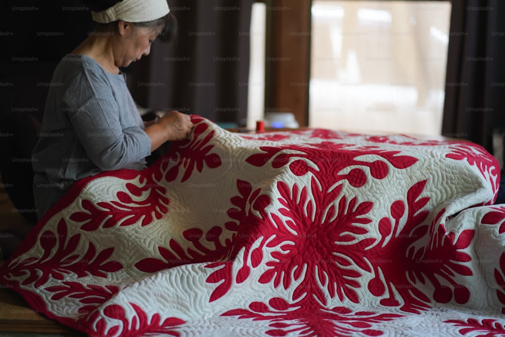 A woman making a Hawaiian quilt