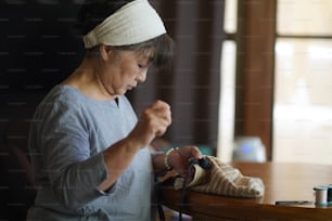 Woman handcrafting a bag
