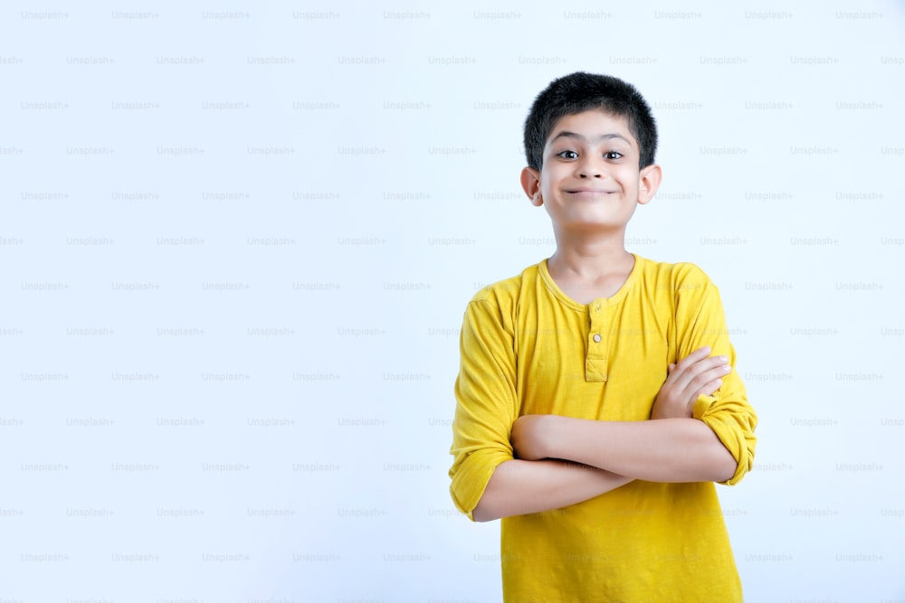 young cute indian child standing over white background