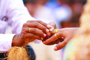 Indian Traditional Wedding: Groom putting ring in finger