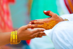 Indian Traditional Wedding: bridal hand in haldi ceremony