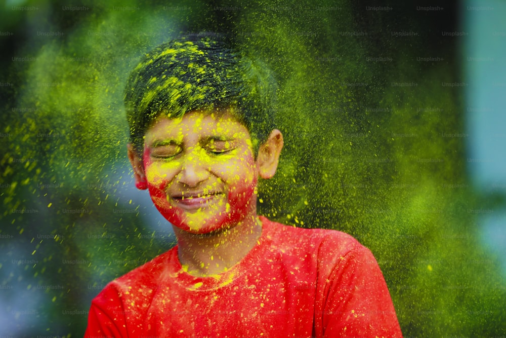 Holi celebrations -Indian little boy playing Holi and showing face expression.