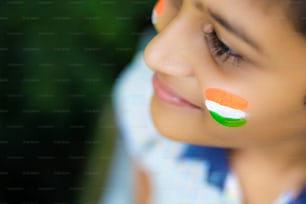 young indian child with indian flag on face