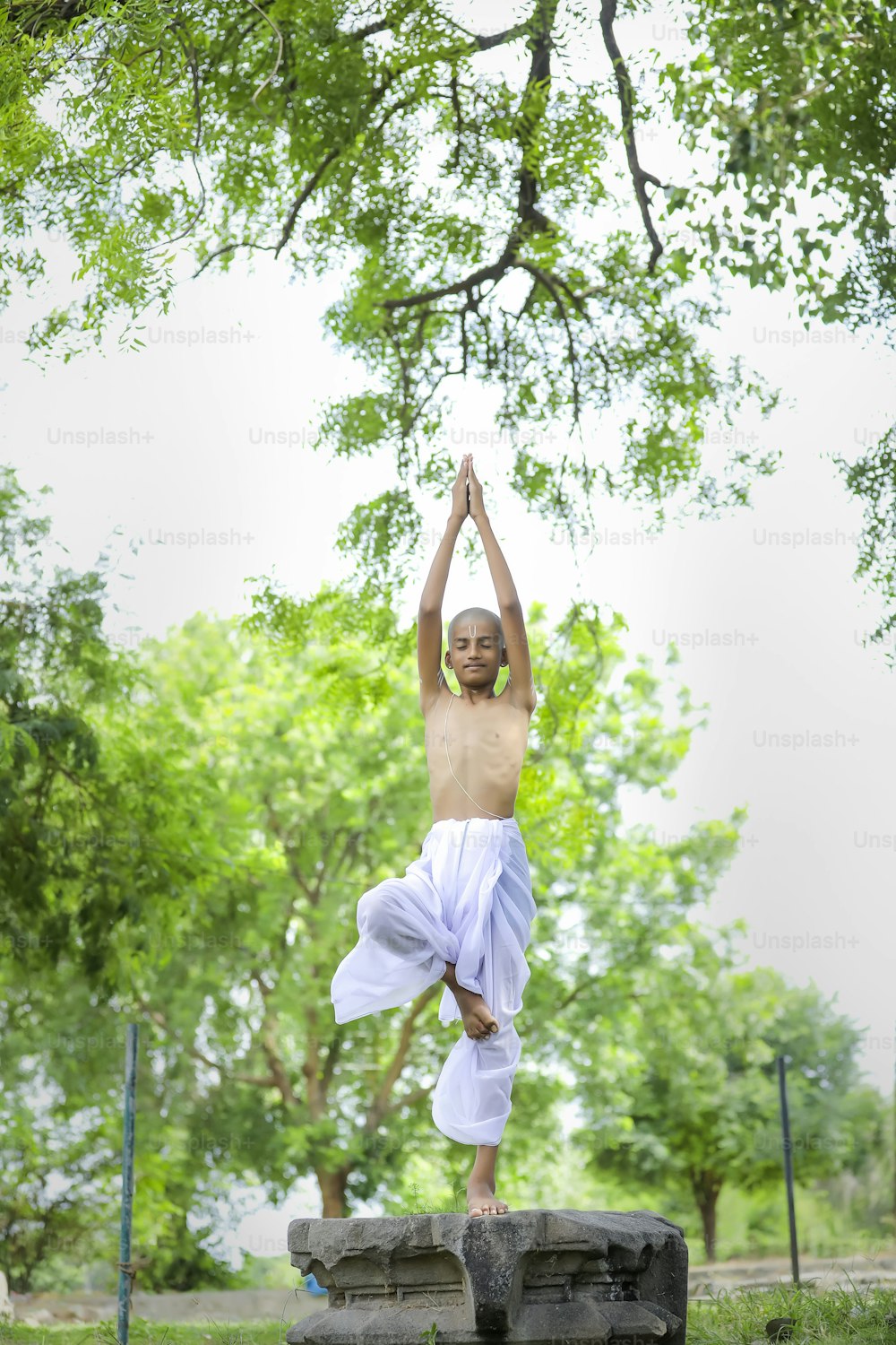 the indian priest child doing meditation